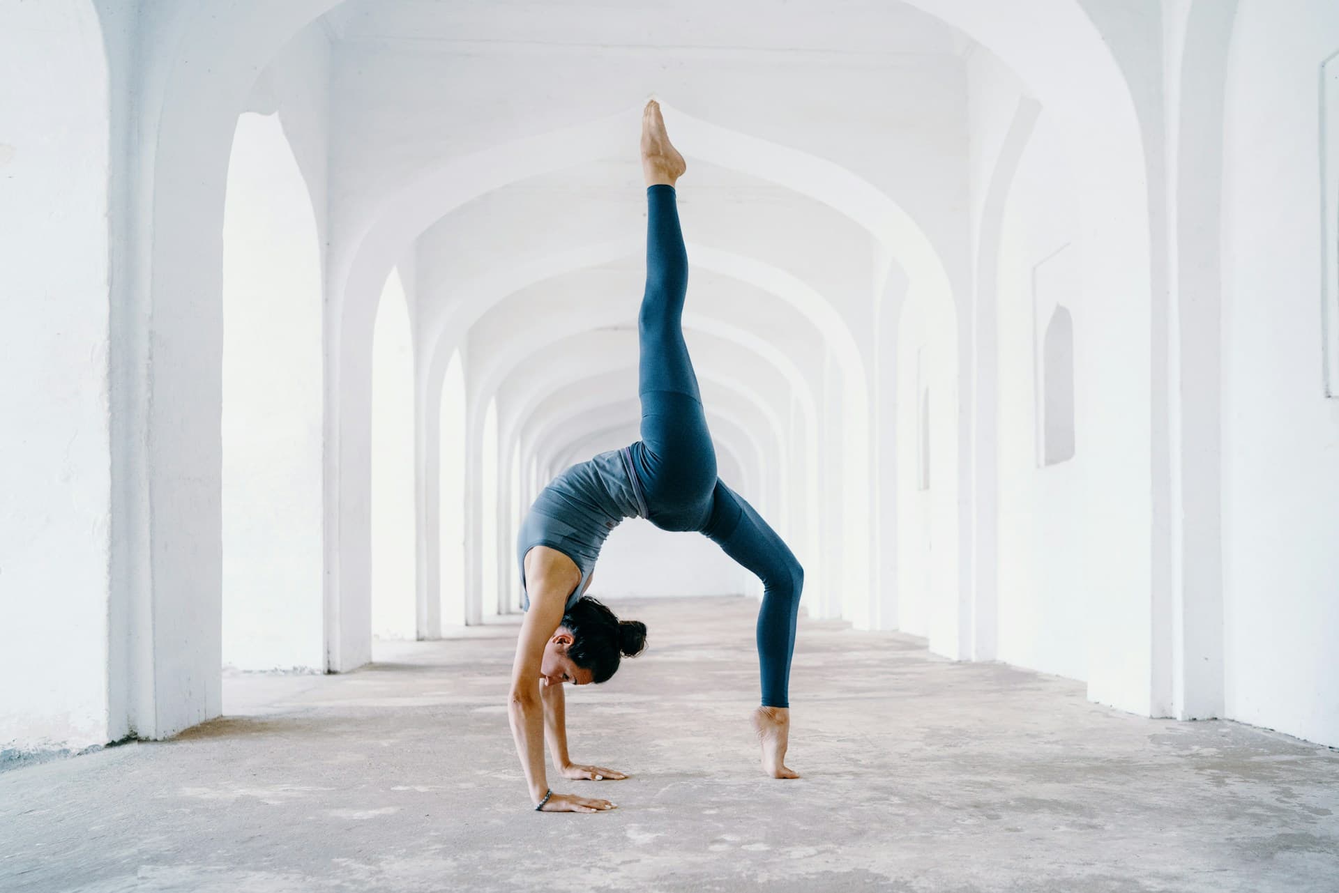 Person practicing yoga on beach